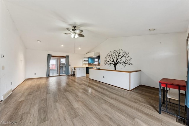 unfurnished living room featuring light wood-style floors, lofted ceiling, visible vents, and ceiling fan