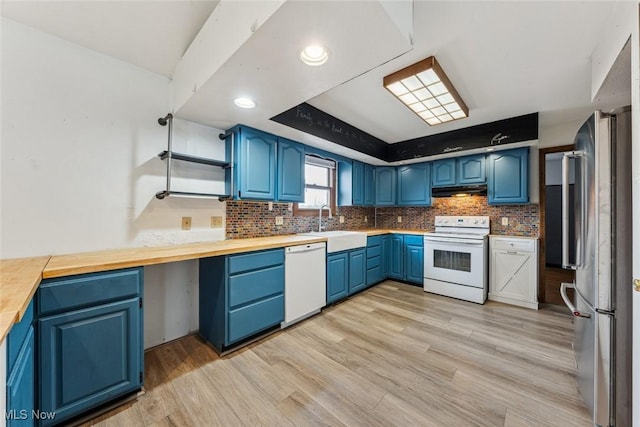 kitchen with under cabinet range hood, white appliances, light wood-style floors, and blue cabinets