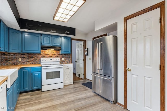 kitchen featuring white appliances, light wood-style flooring, blue cabinetry, light countertops, and under cabinet range hood