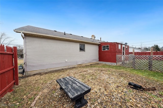 rear view of property with fence