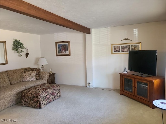 living room featuring carpet floors and beamed ceiling