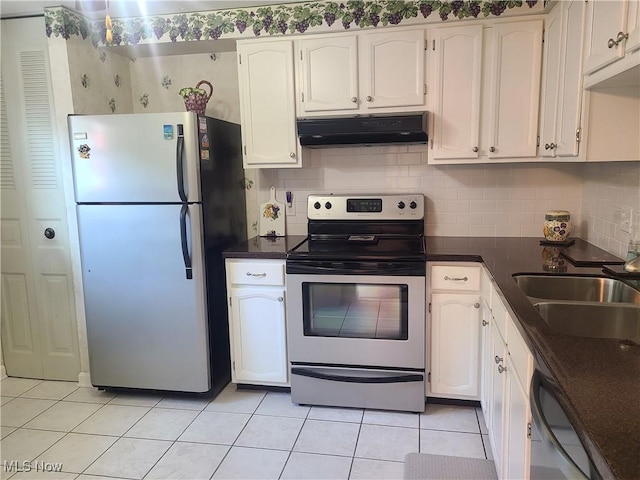 kitchen featuring dark countertops, exhaust hood, appliances with stainless steel finishes, a sink, and light tile patterned flooring