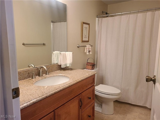 full bath featuring toilet, vanity, and tile patterned floors