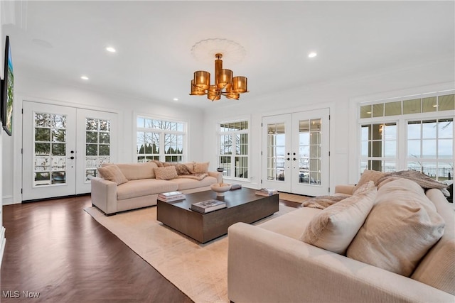 living area with french doors, recessed lighting, and an inviting chandelier