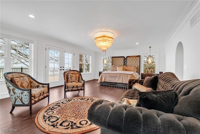 bedroom with access to outside, dark wood-style flooring, a chandelier, crown molding, and arched walkways