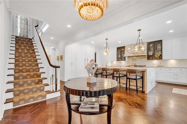 dining space with recessed lighting, a chandelier, and stairs
