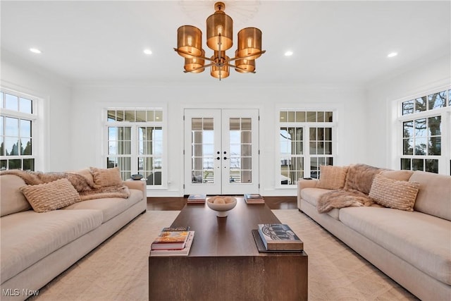 living area featuring french doors, recessed lighting, and a chandelier