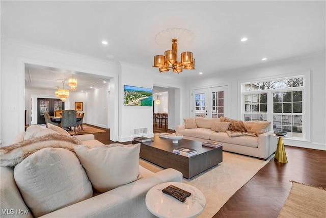 living area featuring wood finished floors, a notable chandelier, visible vents, and recessed lighting