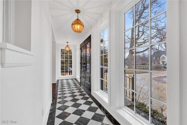 interior space featuring baseboards and dark floors
