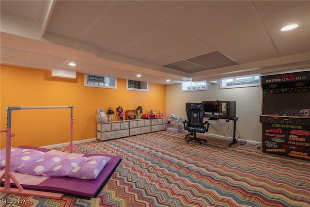 interior space with baseboards, recessed lighting, and a paneled ceiling