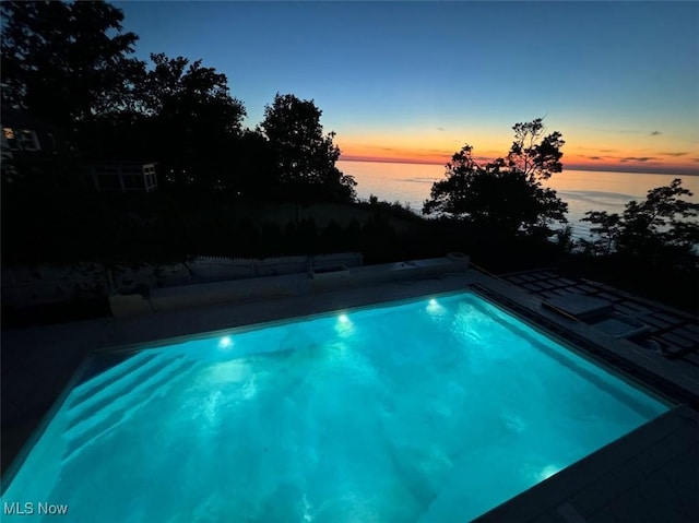 view of swimming pool featuring a water view
