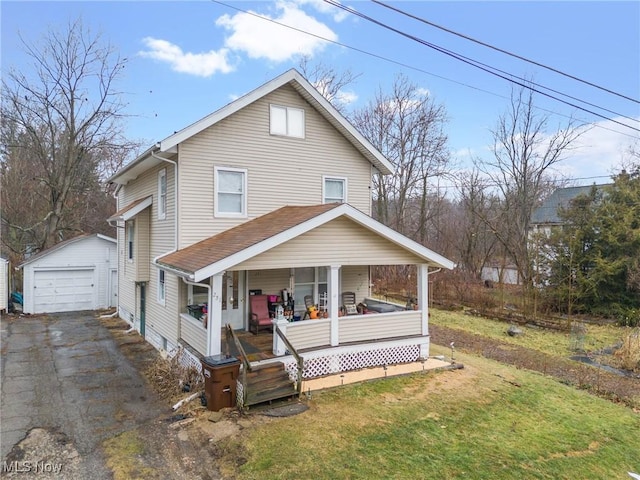 view of front of home featuring an outbuilding, a porch, a detached garage, driveway, and a front yard