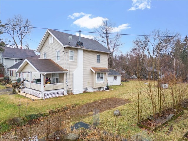 rear view of house featuring a yard and a deck