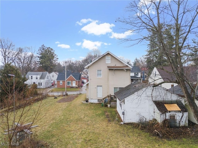 view of side of home featuring a residential view and a yard