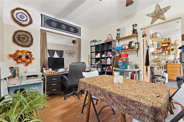 office area featuring a textured ceiling, wood finished floors, and a ceiling fan