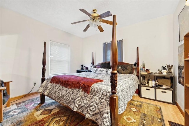 bedroom featuring visible vents, ceiling fan, baseboards, and wood finished floors