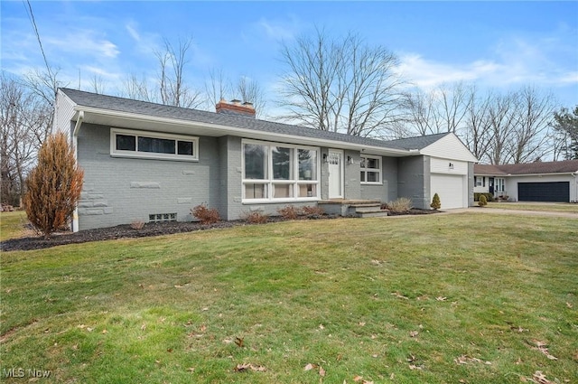 ranch-style home with brick siding, a chimney, a garage, driveway, and a front lawn