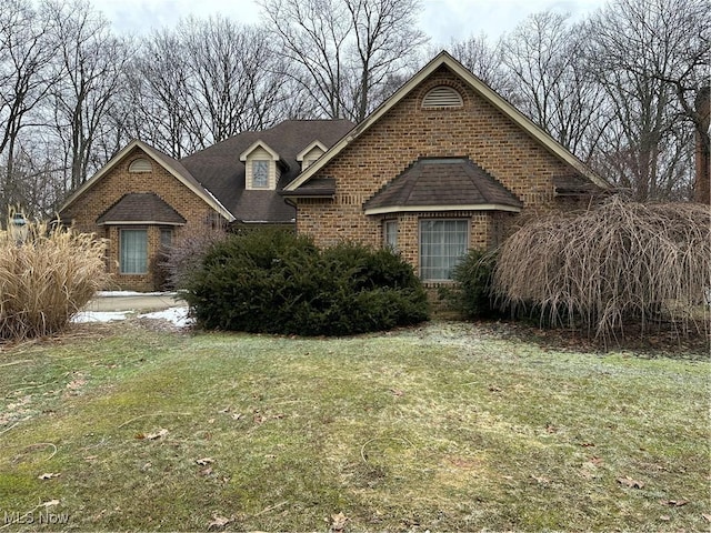 view of front of house with brick siding and a front yard