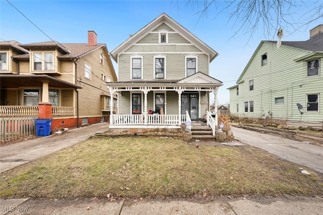 view of front of home with a porch and a front yard