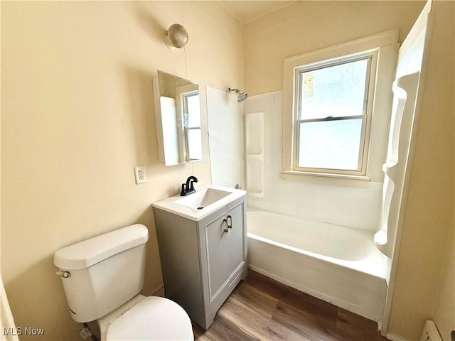 bathroom with shower / tub combination, vanity, toilet, and wood finished floors