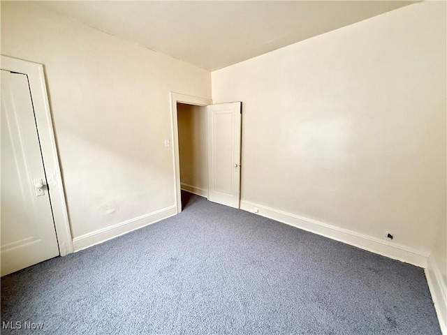 unfurnished bedroom featuring carpet and baseboards