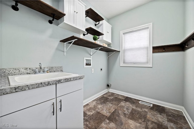 clothes washing area featuring hookup for a washing machine, a sink, visible vents, baseboards, and electric dryer hookup