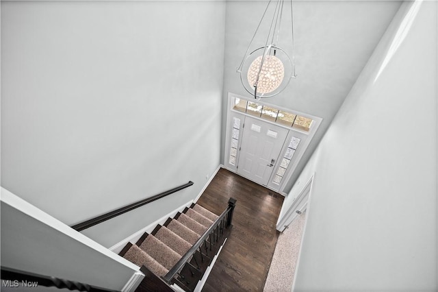 entrance foyer with dark wood-style floors and stairway