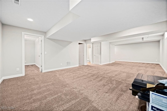 finished basement featuring carpet floors, baseboards, and visible vents