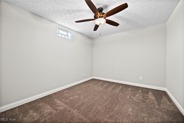 unfurnished room featuring a textured ceiling, ceiling fan, dark carpet, and baseboards