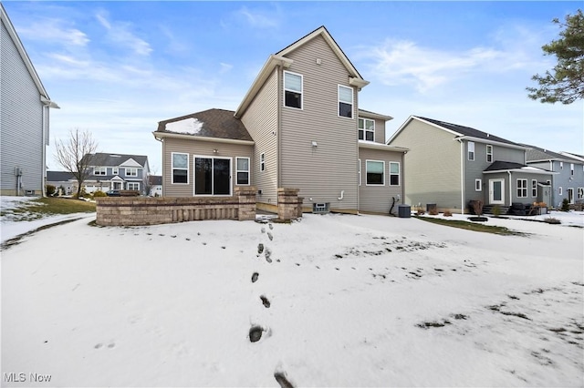 snow covered house with cooling unit