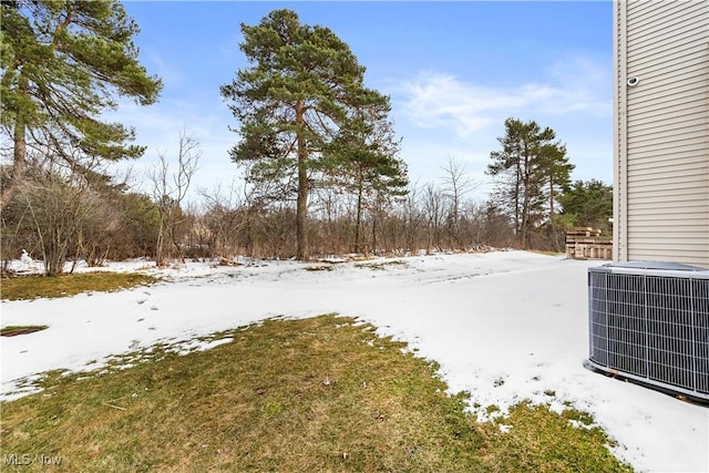 snowy yard with central AC unit