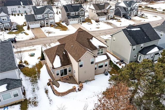 snowy aerial view with a residential view