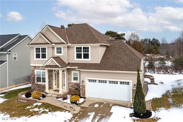 craftsman inspired home featuring a garage, stone siding, a shingled roof, and concrete driveway