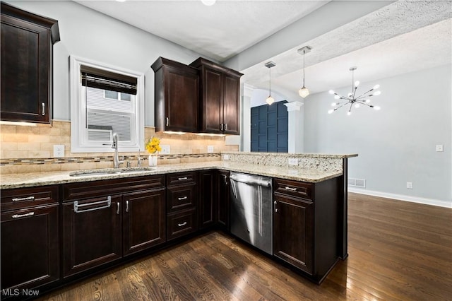 kitchen featuring a peninsula, a sink, dark wood-style floors, light stone countertops, and dishwasher