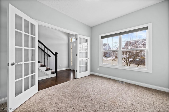 entryway featuring baseboards, visible vents, stairway, french doors, and carpet floors