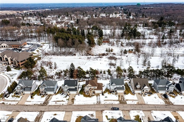 snowy aerial view featuring a residential view