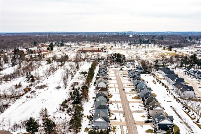 snowy aerial view with a residential view