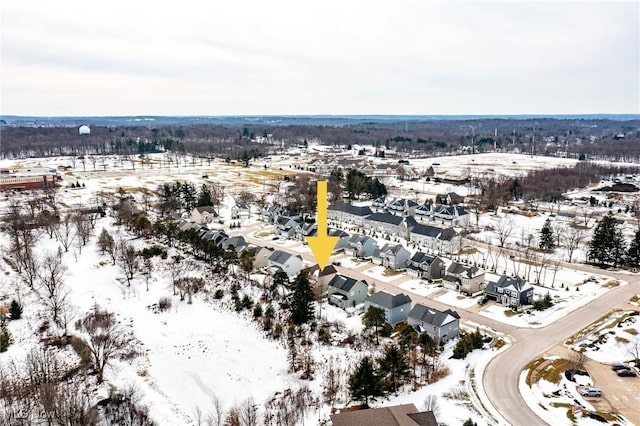 snowy aerial view with a residential view