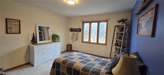 bedroom featuring baseboards, a textured ceiling, and light colored carpet