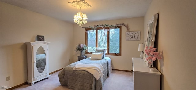 bedroom featuring light carpet, baseboards, and a notable chandelier