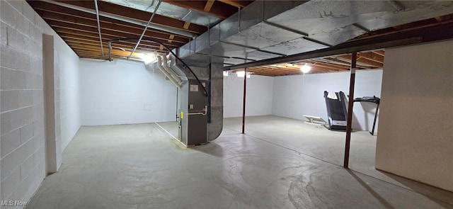 unfinished basement featuring heating unit