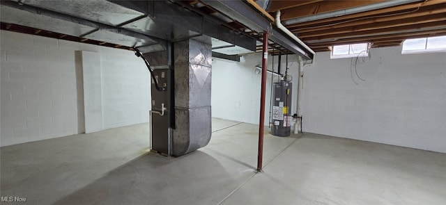 basement with water heater and heating unit