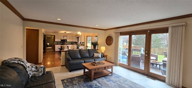 living room featuring recessed lighting, visible vents, crown molding, and french doors