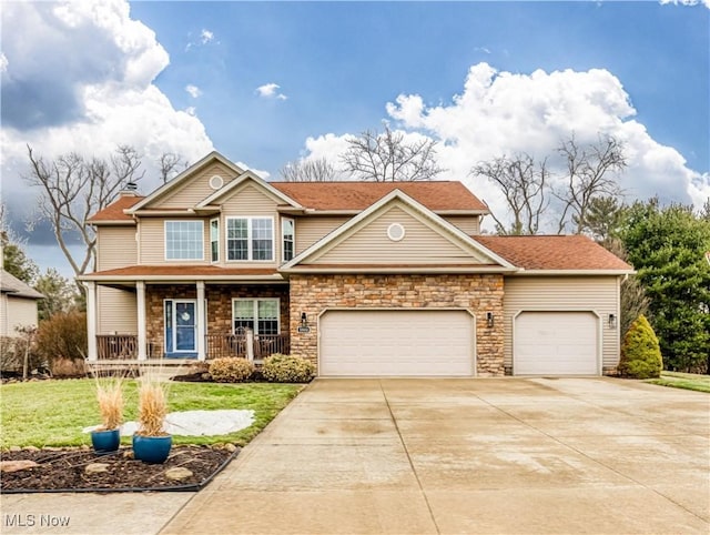 view of front facade featuring covered porch, driveway, a front yard, and a garage