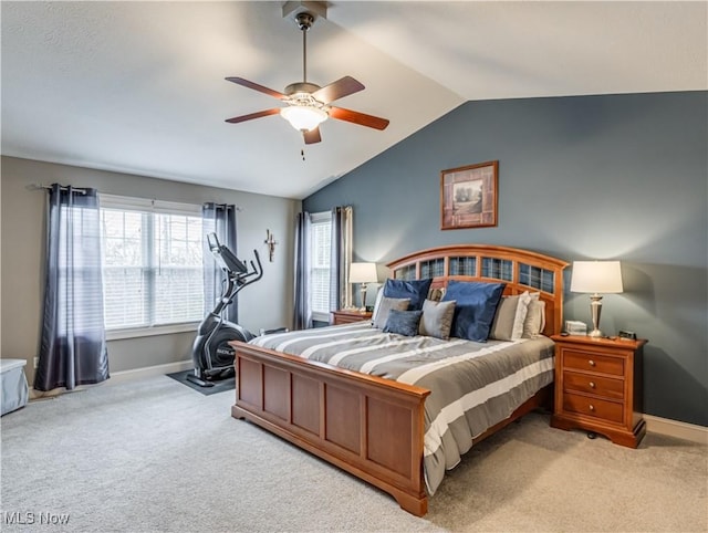 carpeted bedroom featuring a ceiling fan, lofted ceiling, and baseboards