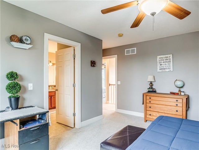 bedroom with light colored carpet, ceiling fan, visible vents, and baseboards