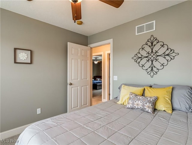 carpeted bedroom featuring visible vents, ceiling fan, and baseboards