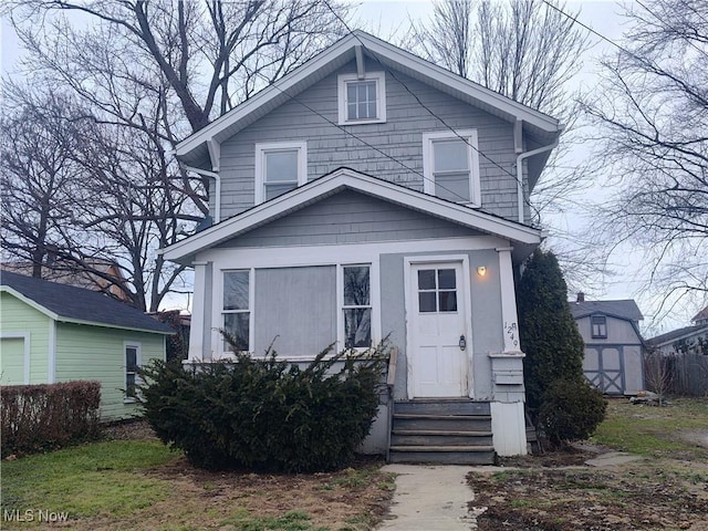 traditional style home with an outbuilding, a storage shed, and entry steps