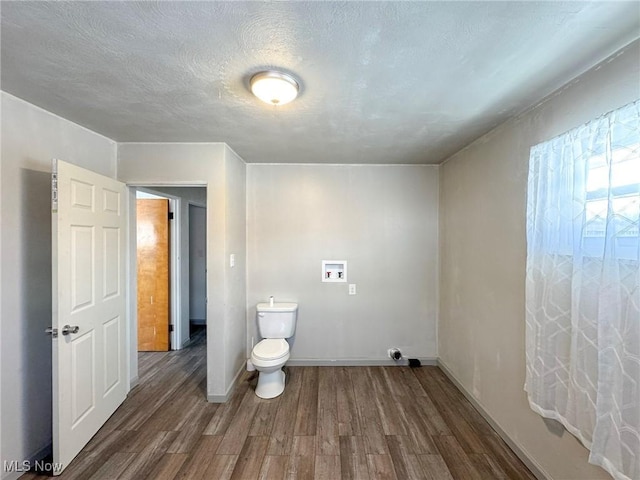 bathroom featuring baseboards, a textured ceiling, toilet, and wood finished floors