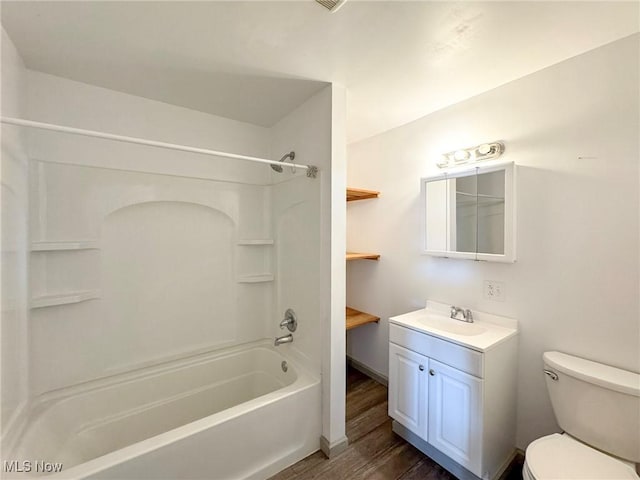 full bathroom with washtub / shower combination, vanity, toilet, and wood finished floors